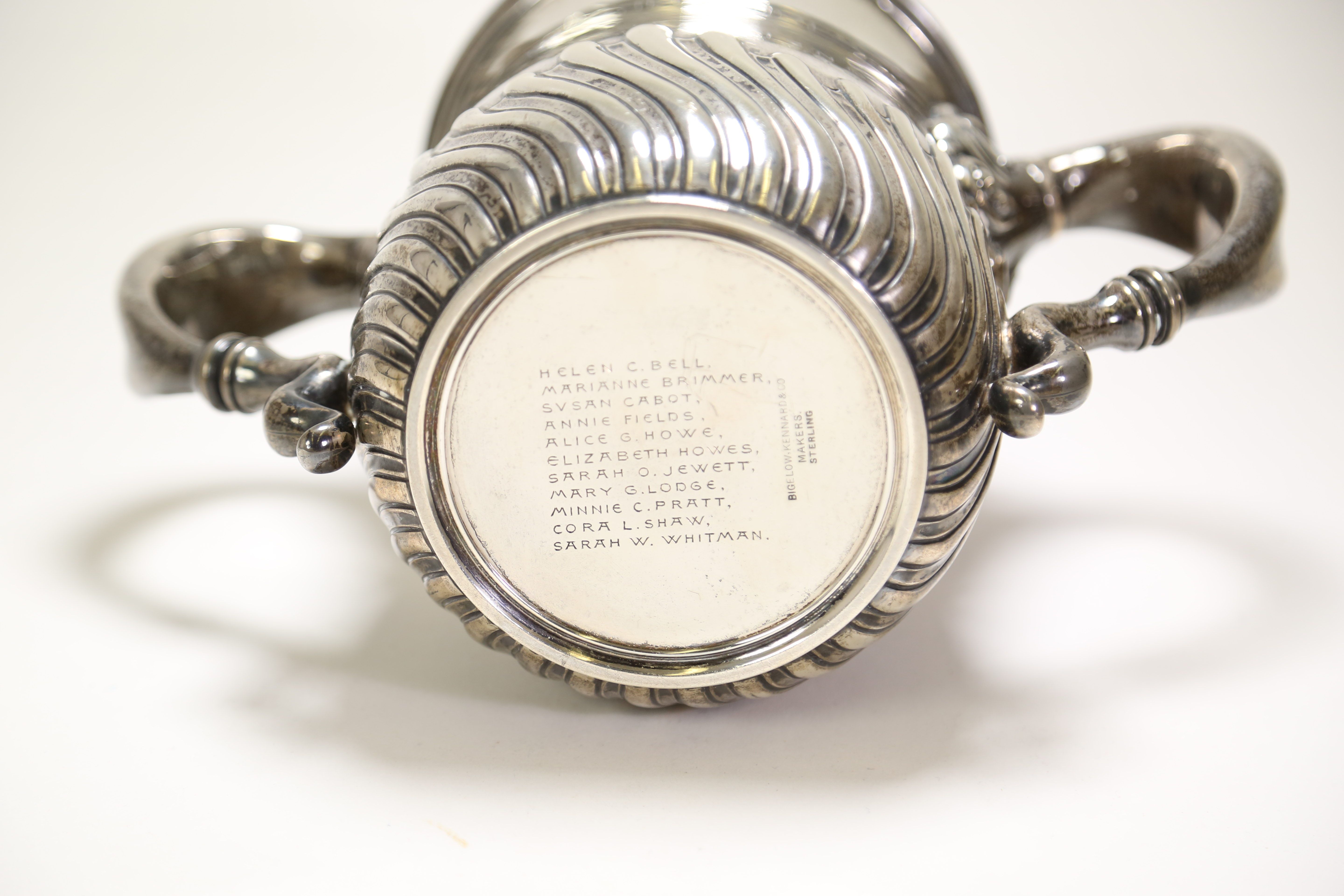 Bottom of silver friendship cup showing a sterling makers mark from Bigelow, Kennard & Co., and the names of 11 people: Helen C. Bell, Marianne Brimmer, Susan Cabot, Annie Fields, Alice G. Howe, Elizabeth Howes, Sarah O. Jewett, Mary G. Lodge, Minnie C. Pratt, Cora L. Shaw, and Sarah W. Whitman