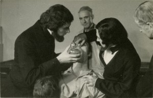 Men demonstrating how to administer anesthesia to a patient.