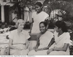 Eleanor Mason sitting with three Indian women in front of tropical plants. 
