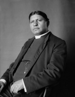 Reverend Sherman Coolidge, seated