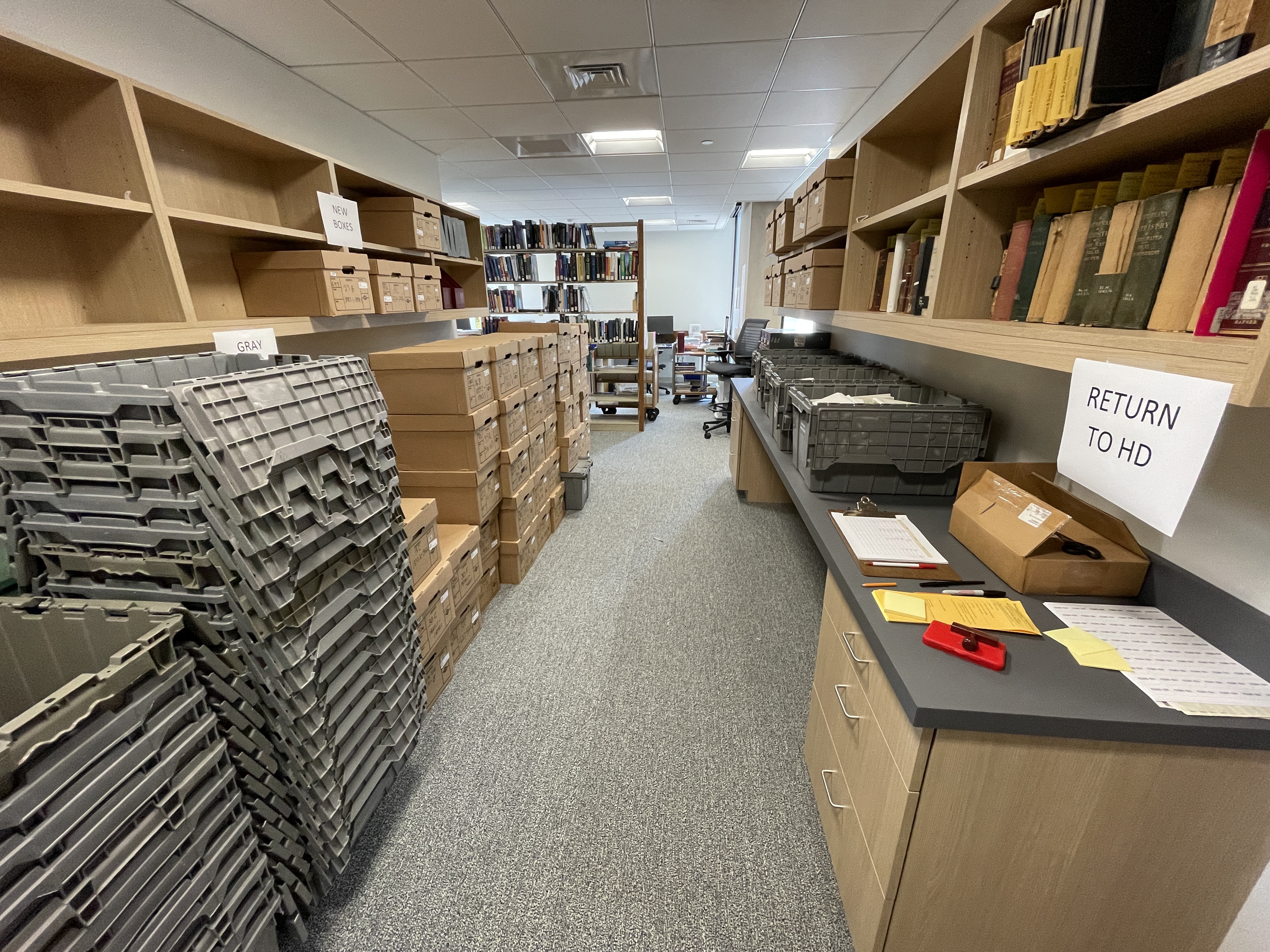 brown boxes and grey bins of book inventory