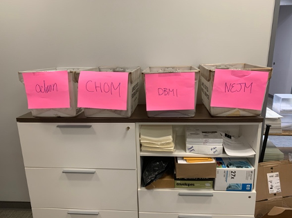 mail sorting table with bins for admin, CHOM, DBMI, and NEJM