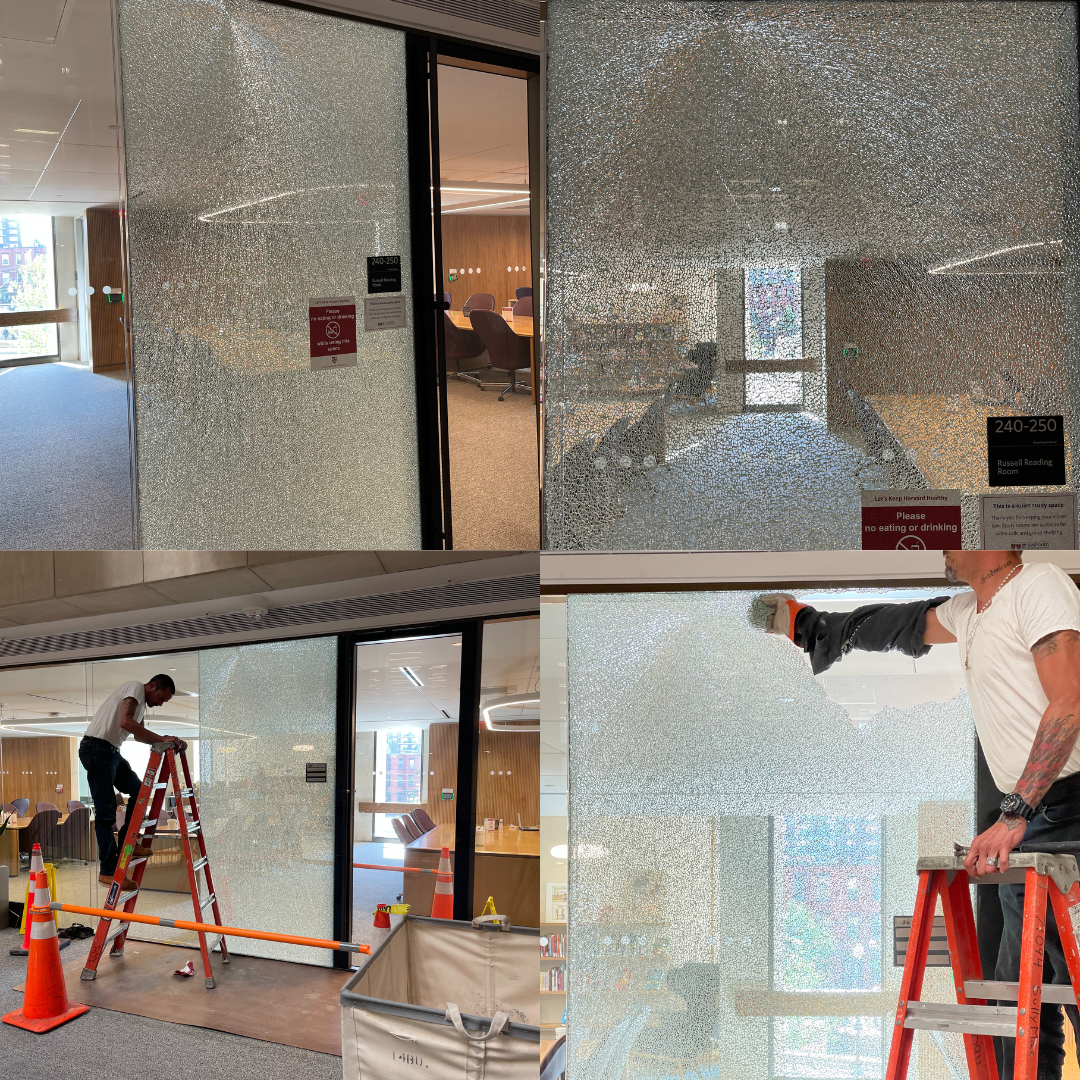 shattered glass wall being cleaned up