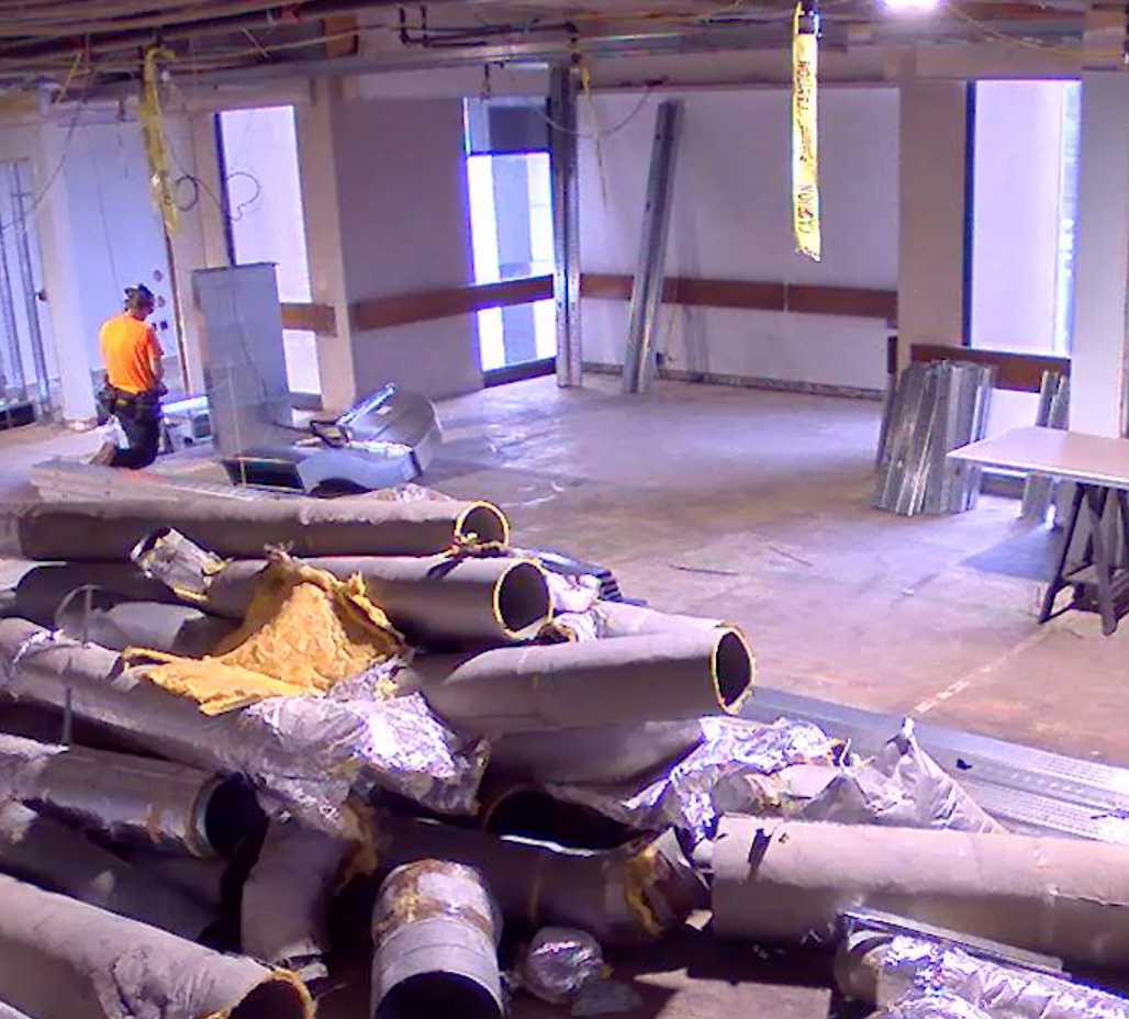 reading room with ceiling panels removed and debris on the floor