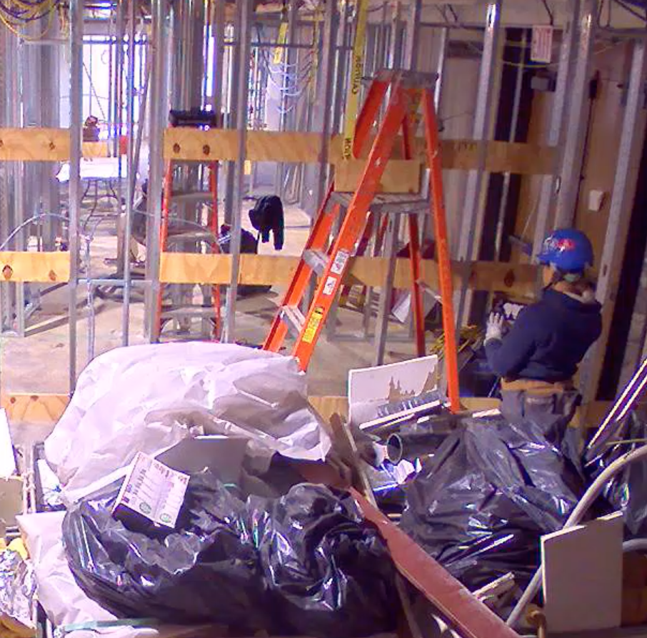 Garbage bags of construction materials on the floor. Dry wall work prep from construction worker.