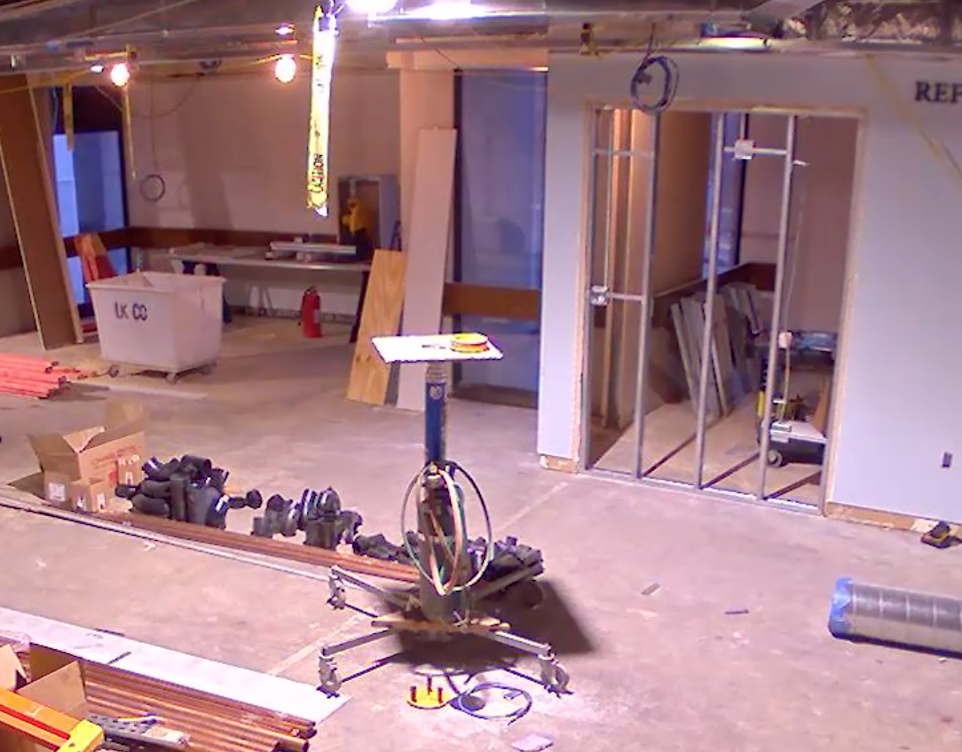 Construction materials spread out on the floor. Doors are removed from the walls.