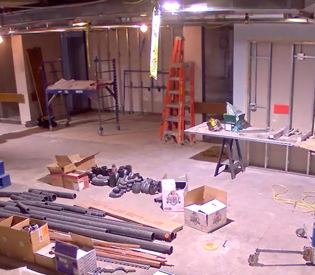 old reading room with floors and ceilings removed. ladders and wires on the floor.