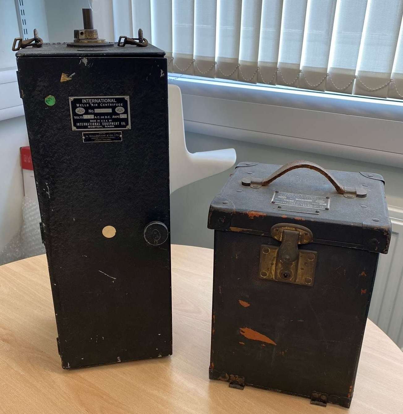 Two historical locked boxes on a table.