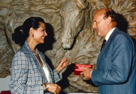 A woman and a man smile at each other 