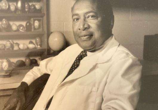 Man in lab coat with egg model collection