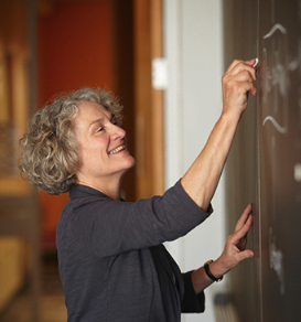 Dr. Nancy M. Kane writing on chalkboard