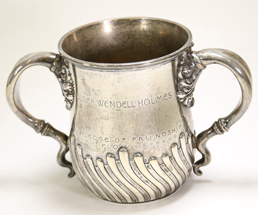 Ornate stemless silver cup with engravings reading: Oliver Wendell Holmes; The pledge of friendship may flow